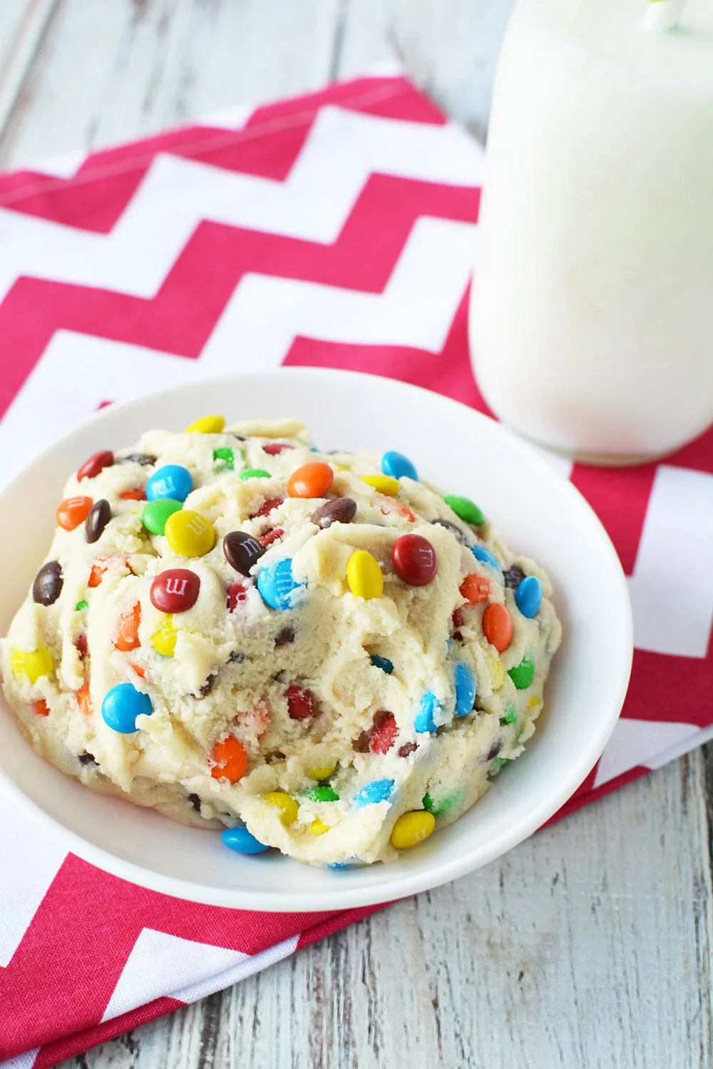 Bowl of cookie dough with a spoonful missing. 