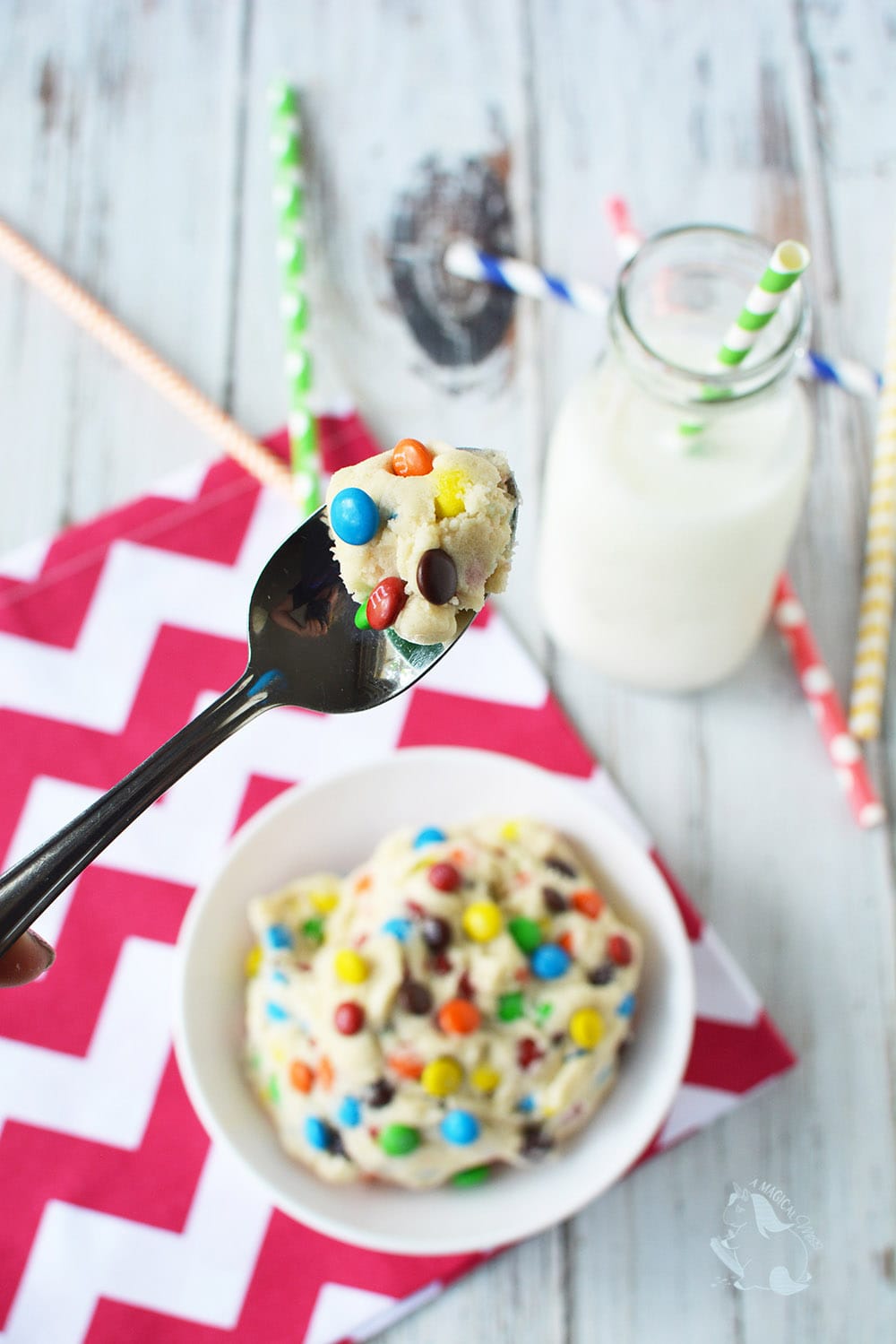 Spoonful of cookie dough dip with mini M&M's.