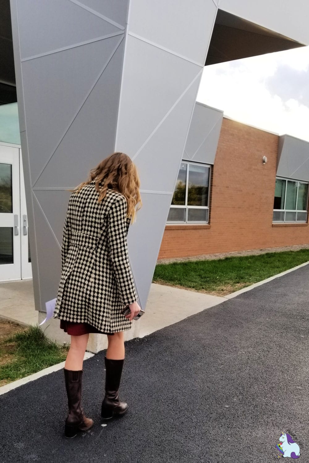 Teenage girl walking outside of a school
