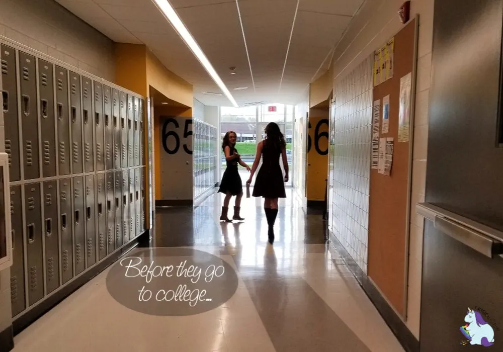 Two girls walking down the hall in school.