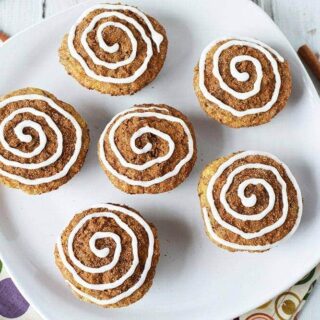 Overhead picture of cinnamon roll muffins on a white plate.