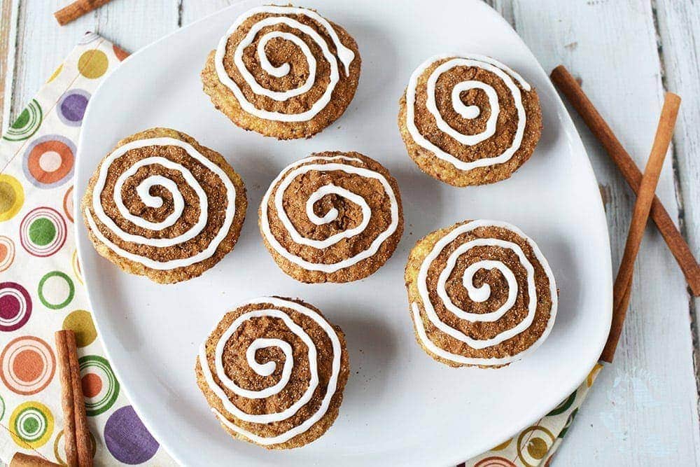 Overhead picture of cinnamon roll muffins on a white plate.