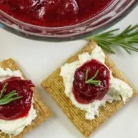 Homemade cranberry jam recipe served on Triscuit crackers with cream cheese.