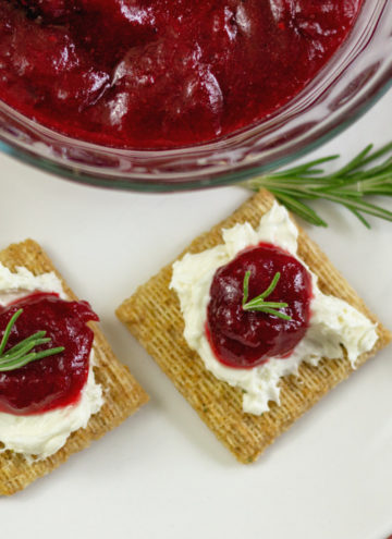 Homemade cranberry jam recipe served on Triscuit crackers with cream cheese.