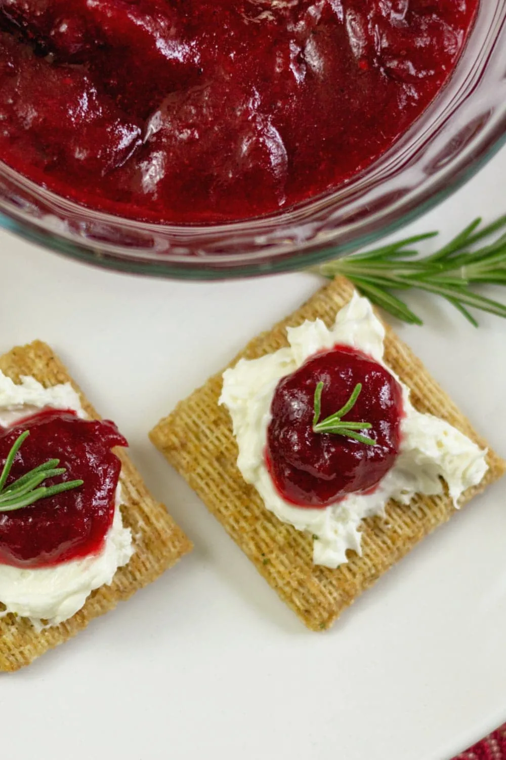 Homemade cranberry jam recipe served on Triscuit crackers with cream cheese.