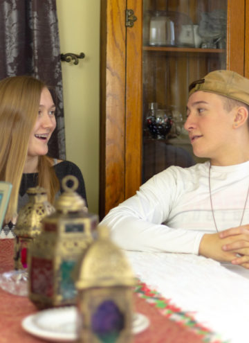 two teens at the dining table answering questions about credit and finances