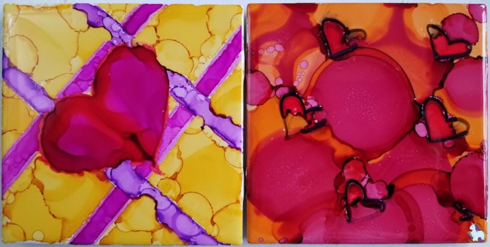 two Valentine's Day themed alcohol ink tiles