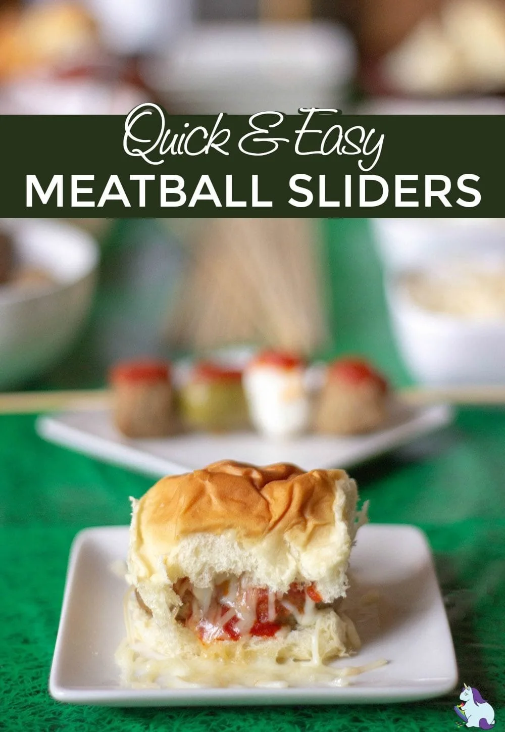 Meatball slider with cheese on a table decorated for game day.