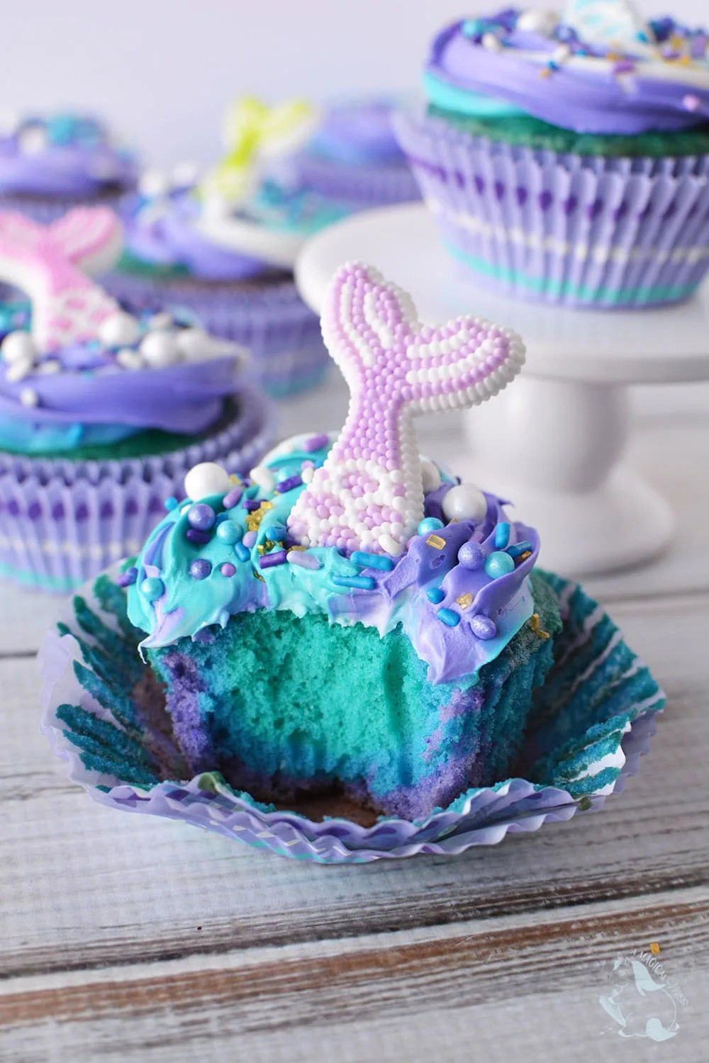 Blue and purple cupcake with a bite taken out.