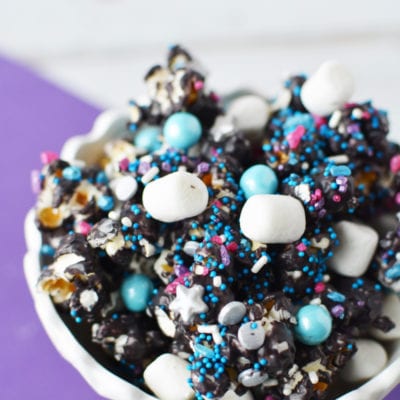 candied popcorn in white dish on purple napkin