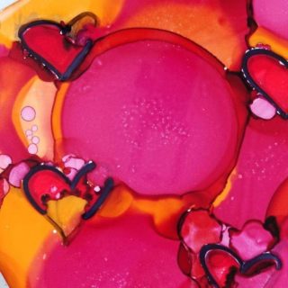 red hearts in alcohol ink on tile