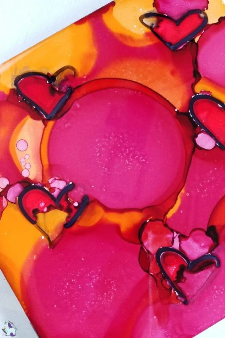 red hearts in alcohol ink on tile