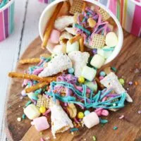 colorful unicorn snack mix spilling out of striped paper cup