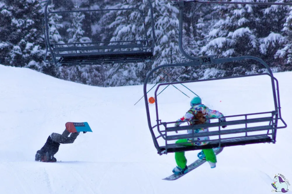 Epic fail snowboarding Bridger Bowl. Man falling on his face with snowboard in the air. 