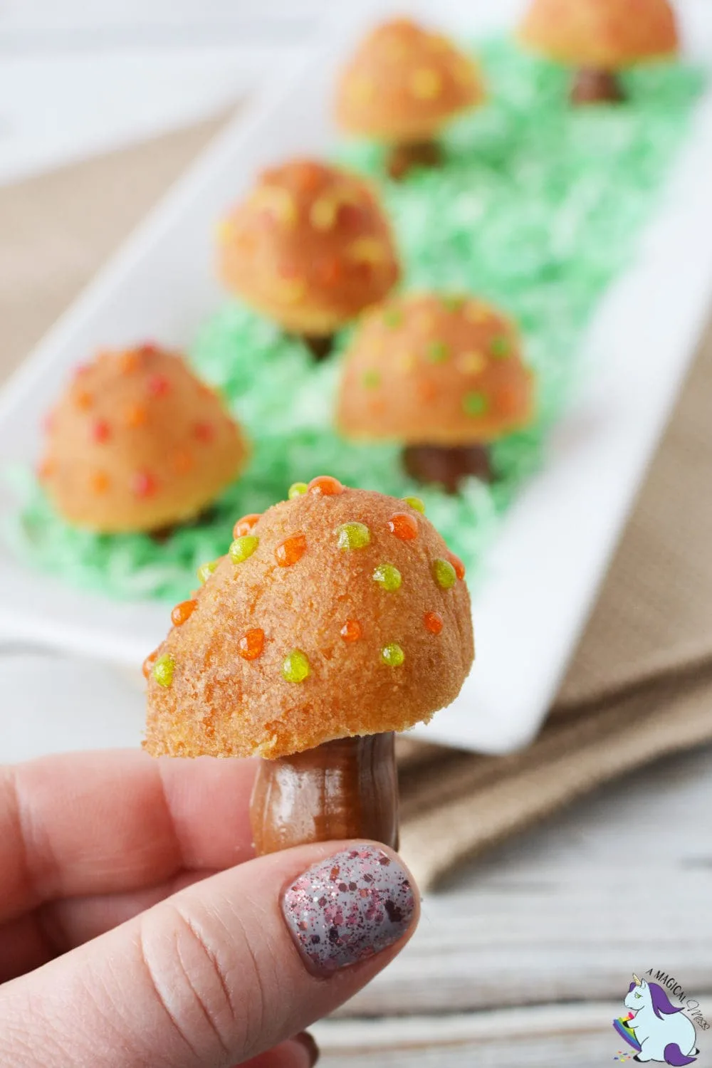 Holding a donut hole with a Tootsie Roll trunk to look like a fairy toadstool. 