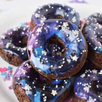 Galaxy donuts stacked on a plate.