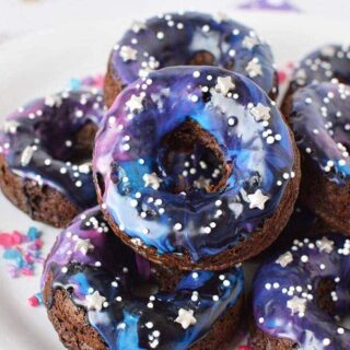 Galaxy donuts stacked on a plate.