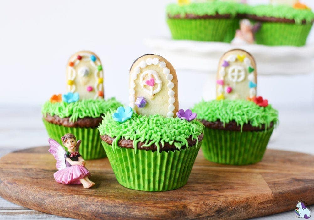Cupcakes topped with "grass" frosting and cookies decorated as doors. 