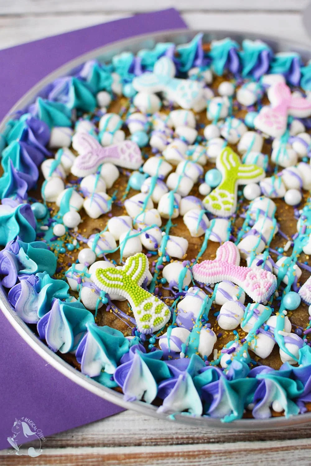 Cookie dessert pizza with mermaid toppings. 