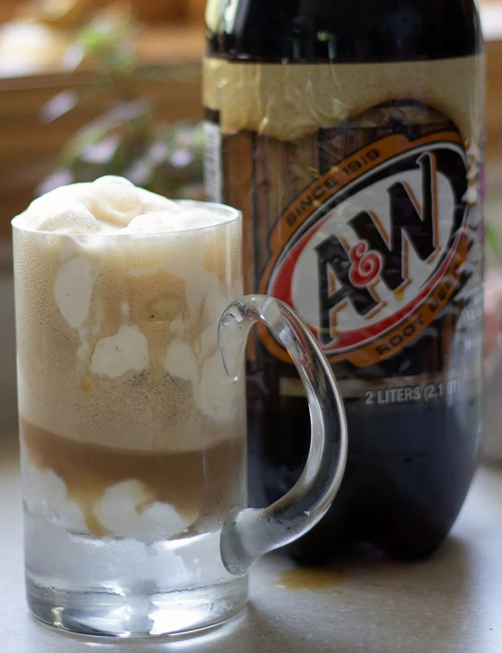 Root beer float and bottle of A&W Root Beer.