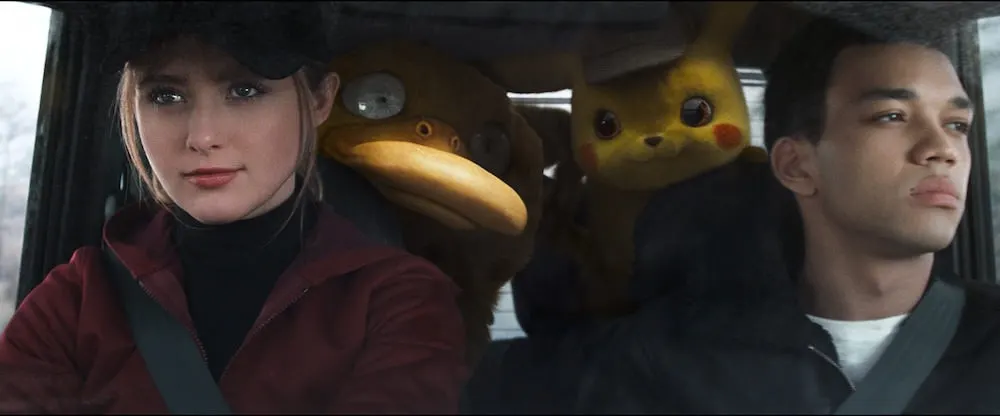 KATRHYN NEWTON as Lucy Stevens, Psyduck, Detective Pikachu (RYAN REYNOLDS) and JUSTICE SMITH as Tim Goodman in Legendary Pictures' and Warner Bros. Pictures' comedy adventure "POKÉMON DETECTIVE PIKACHU," a Warner Bros. Pictures release.