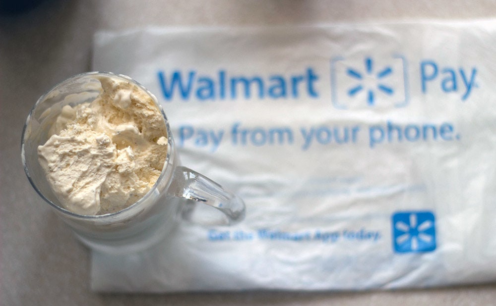 Ice cream in a mug on top of a Walmart bag