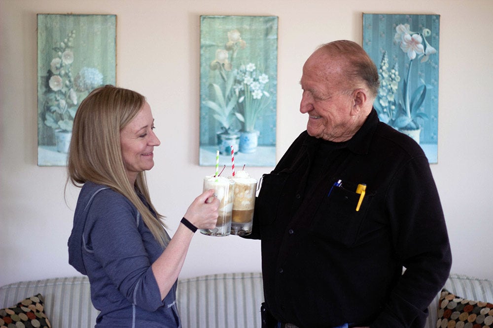 Jen and her grandfather cheersing with root beer floats.
