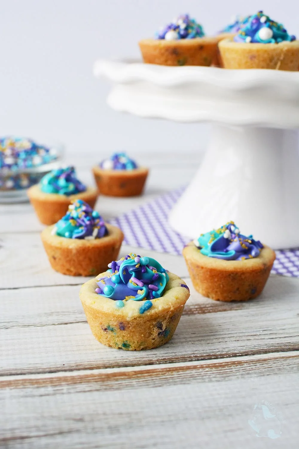 Mermaid cookie cups on a platter and on the table. 