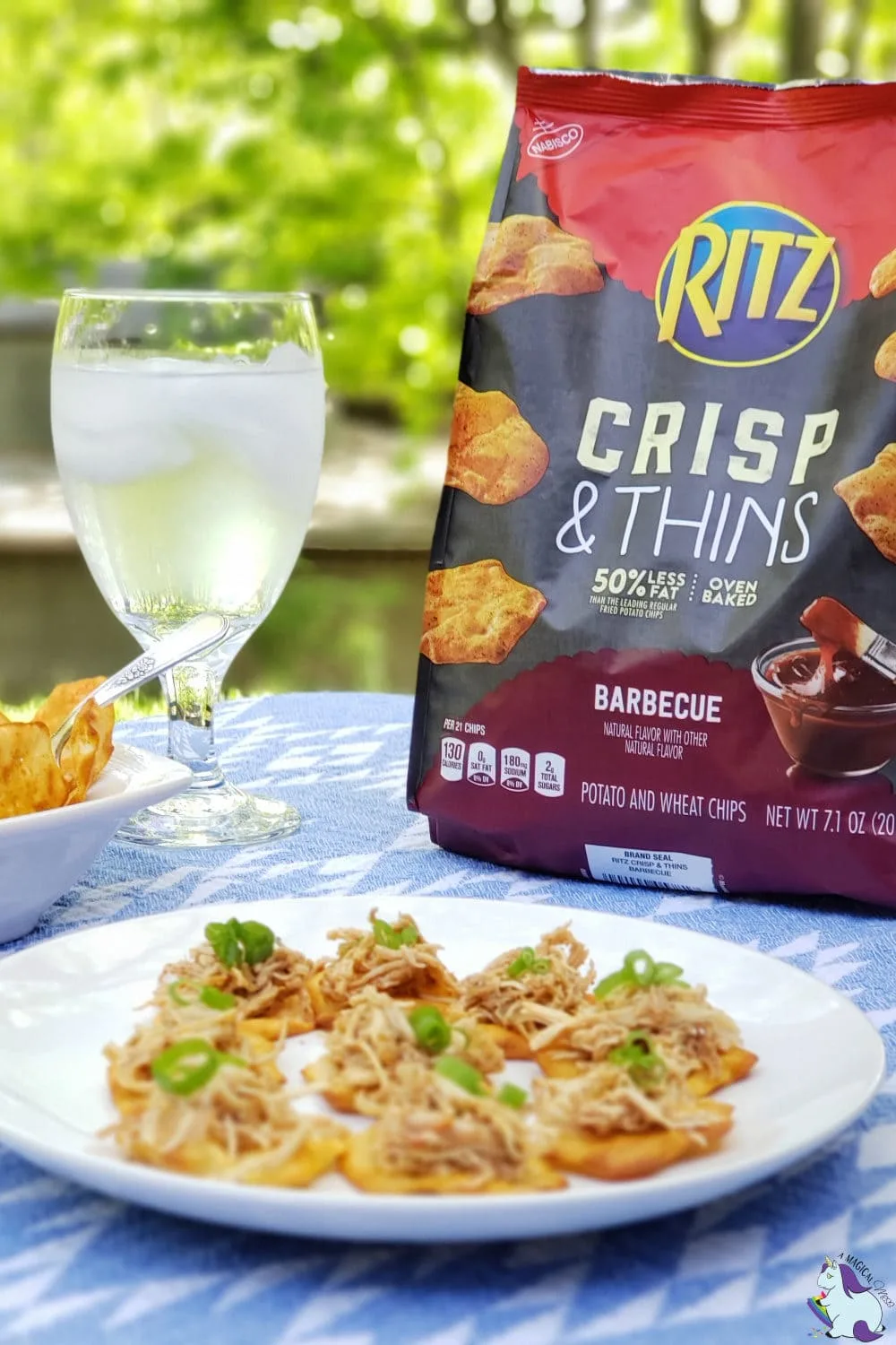 Ritz Crisps in a bag and on a plate with a glass of water on a table. 