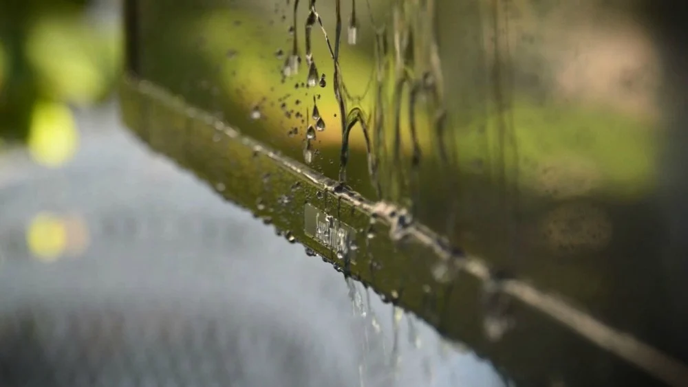 Weatherproof tv with water dripping from it. 