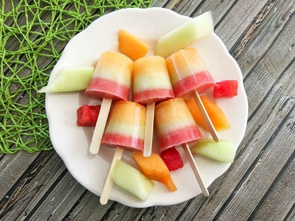 Triple melon frozen pops on a plate.