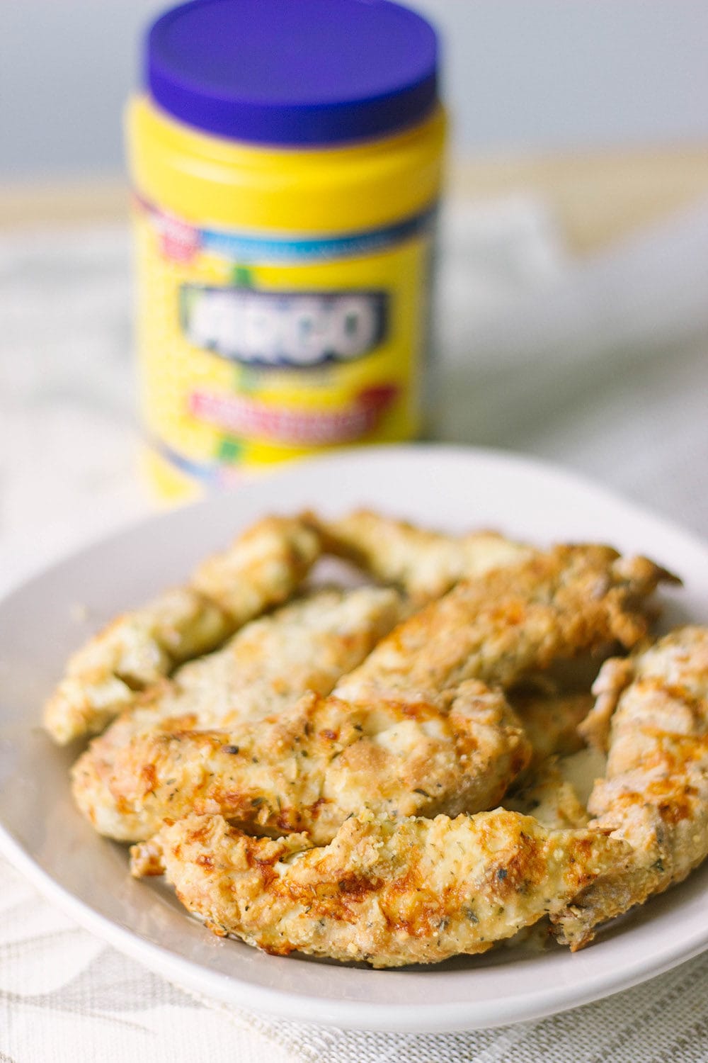Bowl of chicken strips with Argo Corn Starch in the background.
