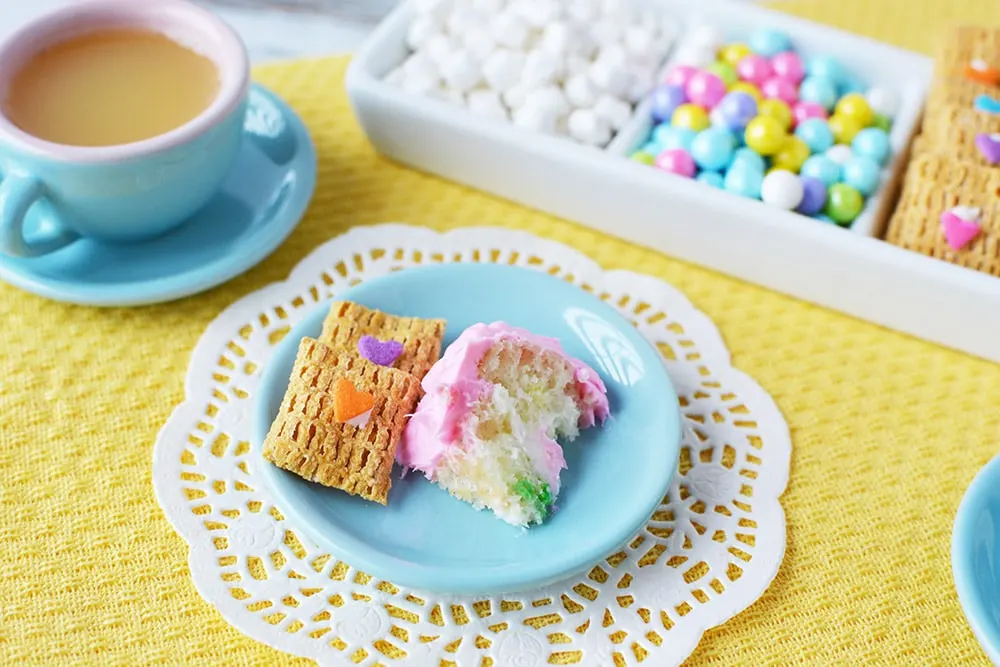 Tiny slice of cake and a fairy cookie at a tea party. 