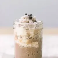 Chocolate shake with whipped cream in a jelly jar.