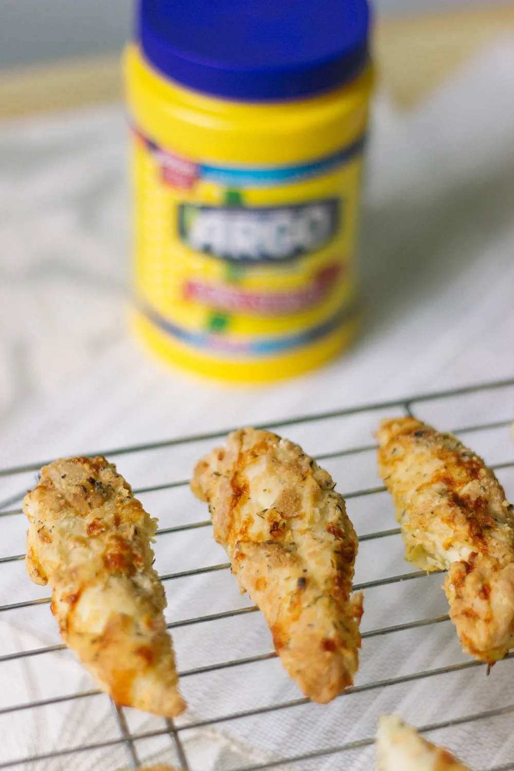 Crispy air fried chicken strips on a rack. 