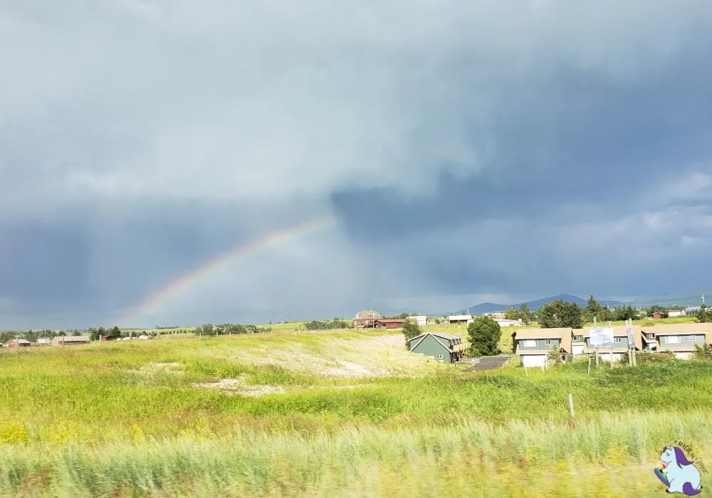 A rainbow in a dark blue sky. 