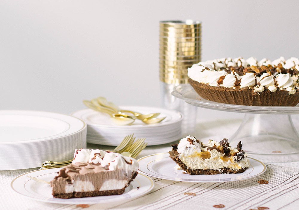 Pies on a table with gold settings.