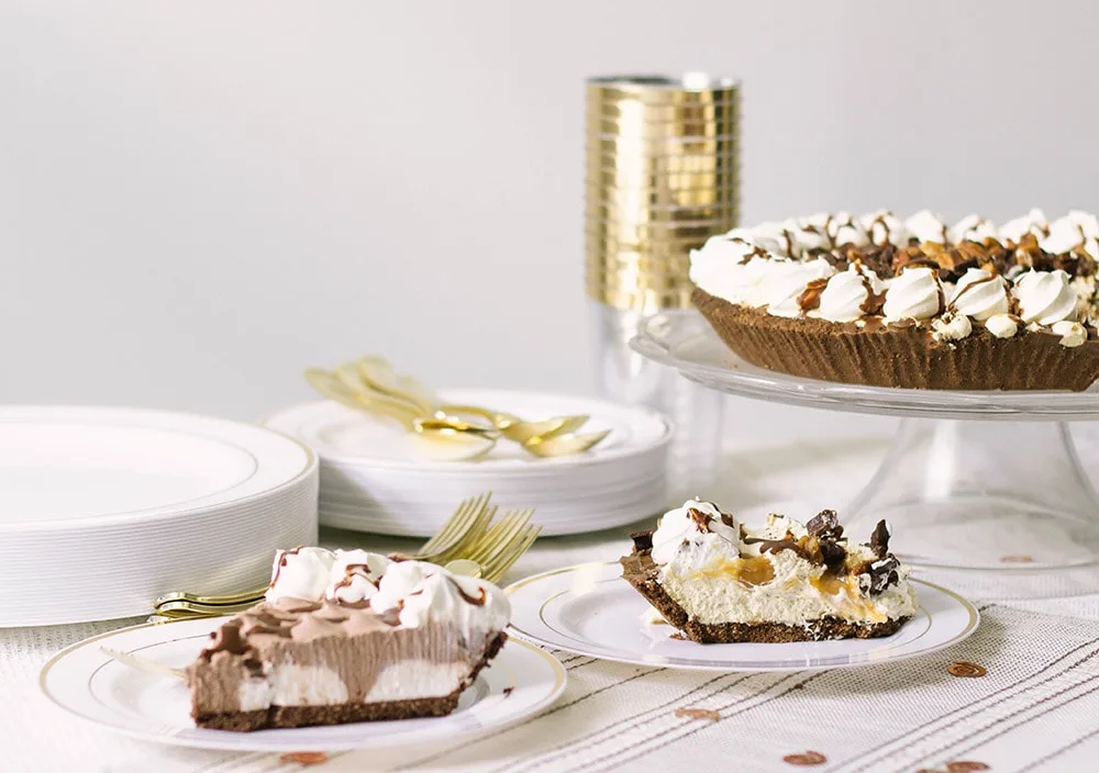 Pies on a table with gold settings. 