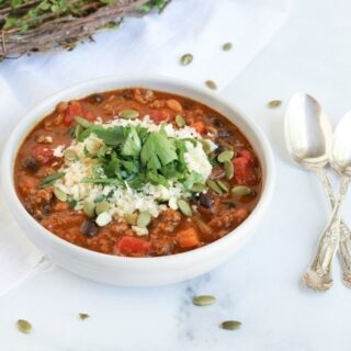 Bowl of chili on a table.