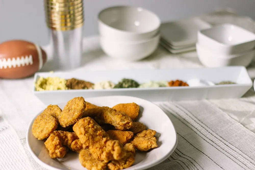 Chicken strip bar with bowls and spices. 