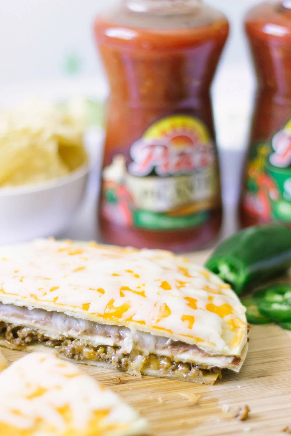 Taco pizza sliced on a board.