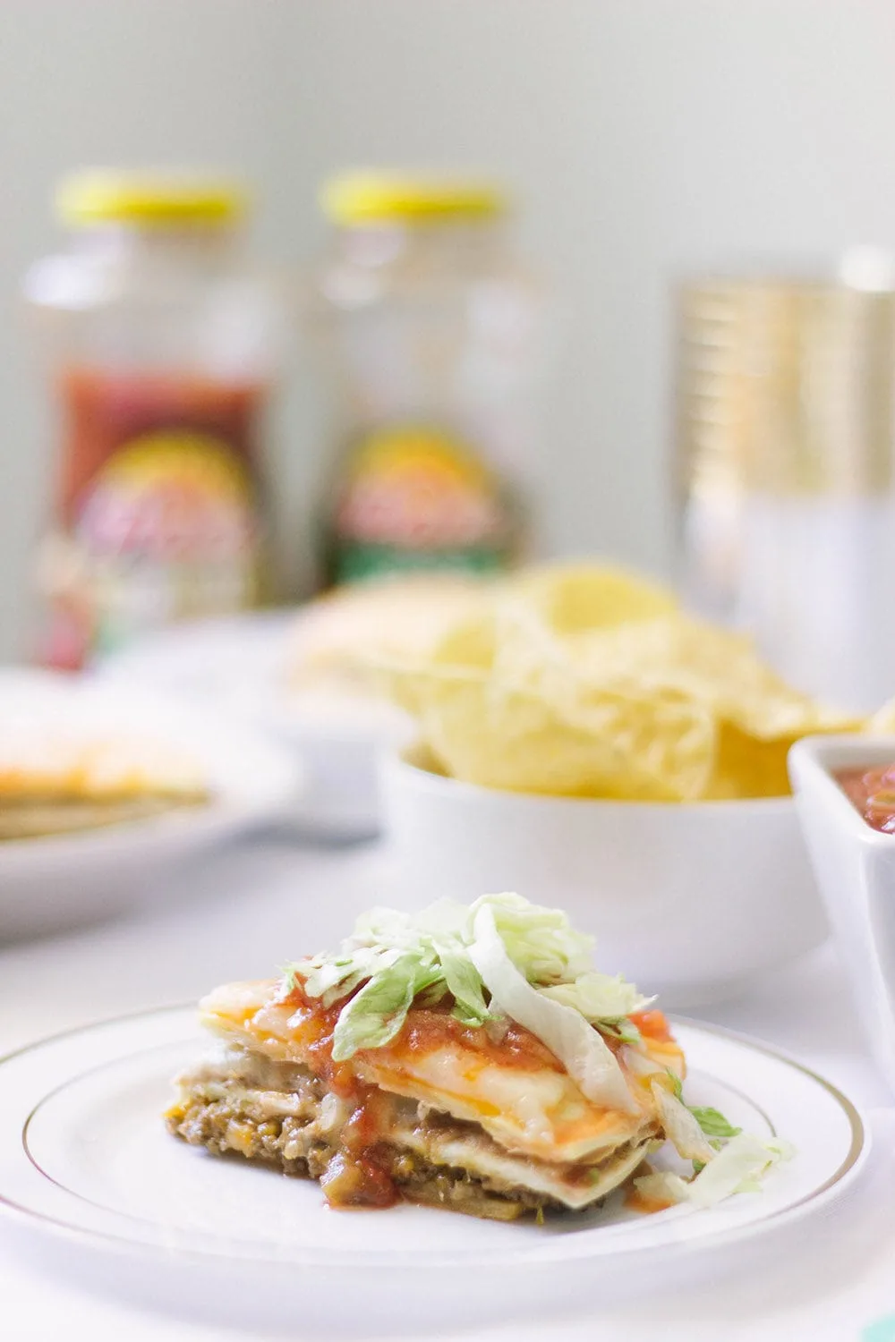 Taco pizza on a plate with toppings. 