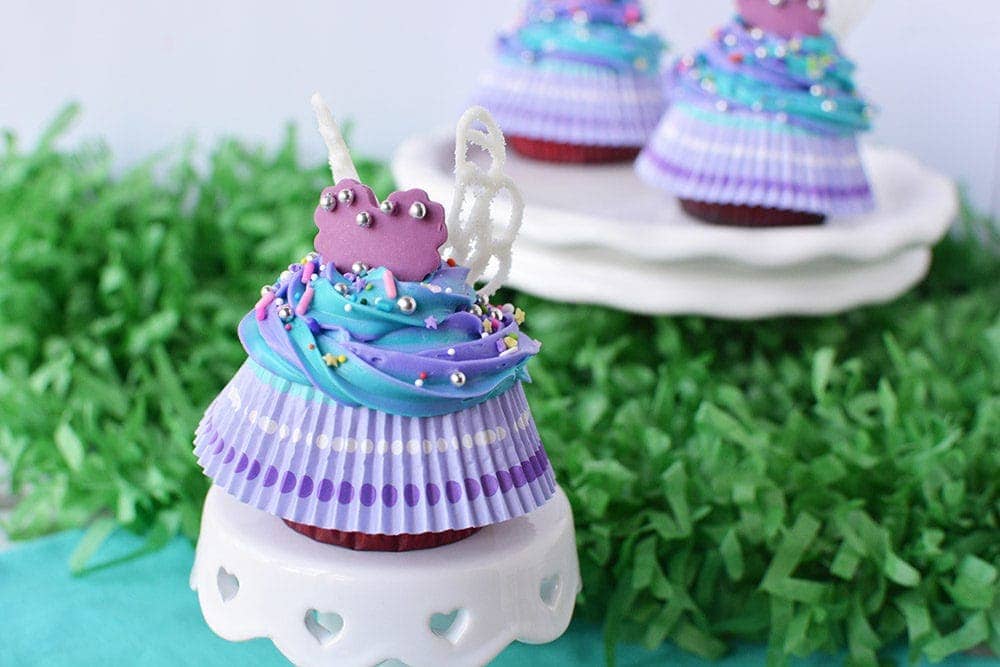 Fairy wing cupcakes on a little cake stand. 