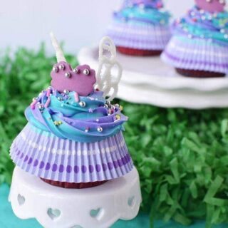 Fairy wing cupcakes on a little cake stand.