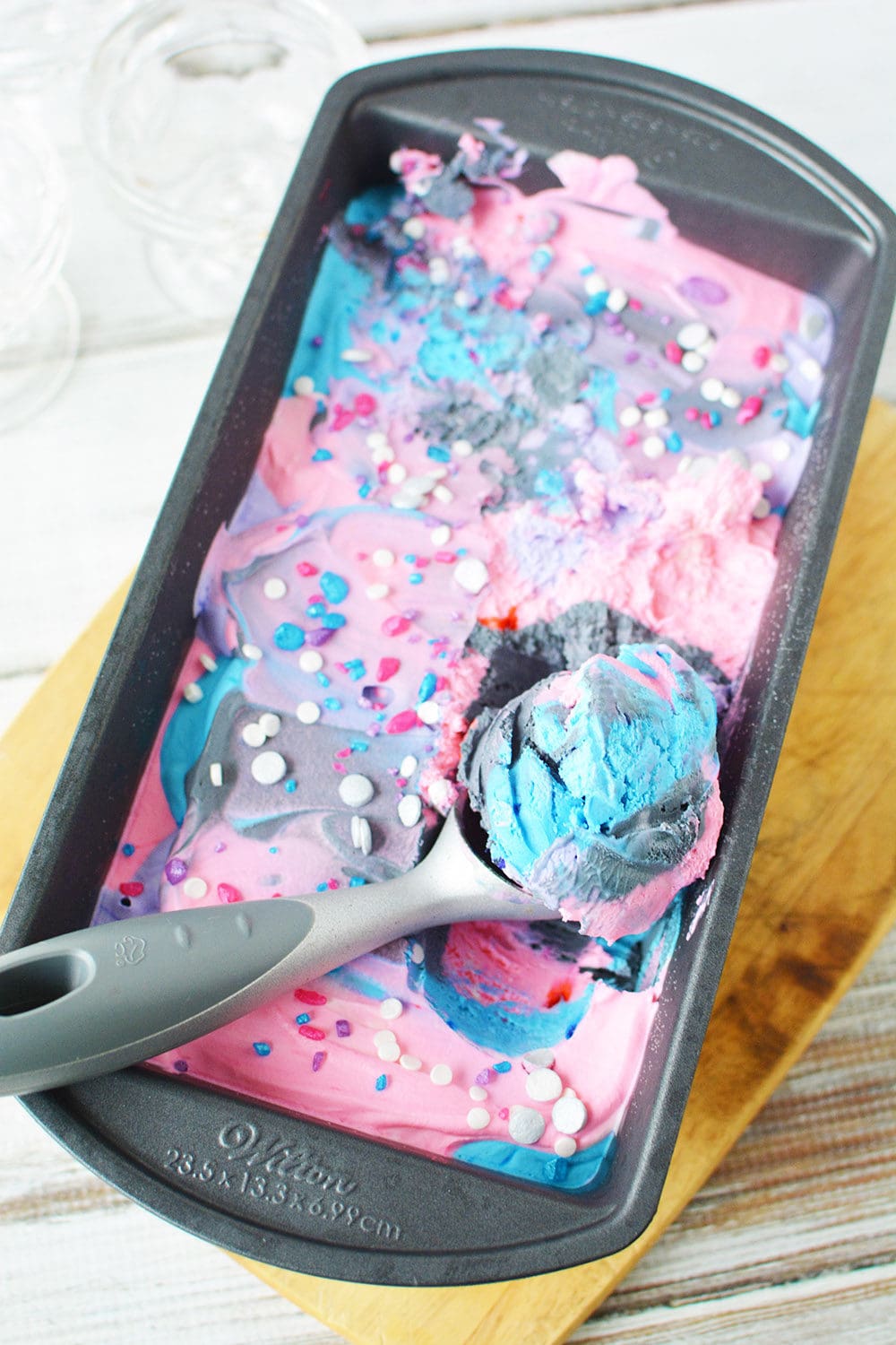 Galaxy ice cream in a pan with a scoop taken out