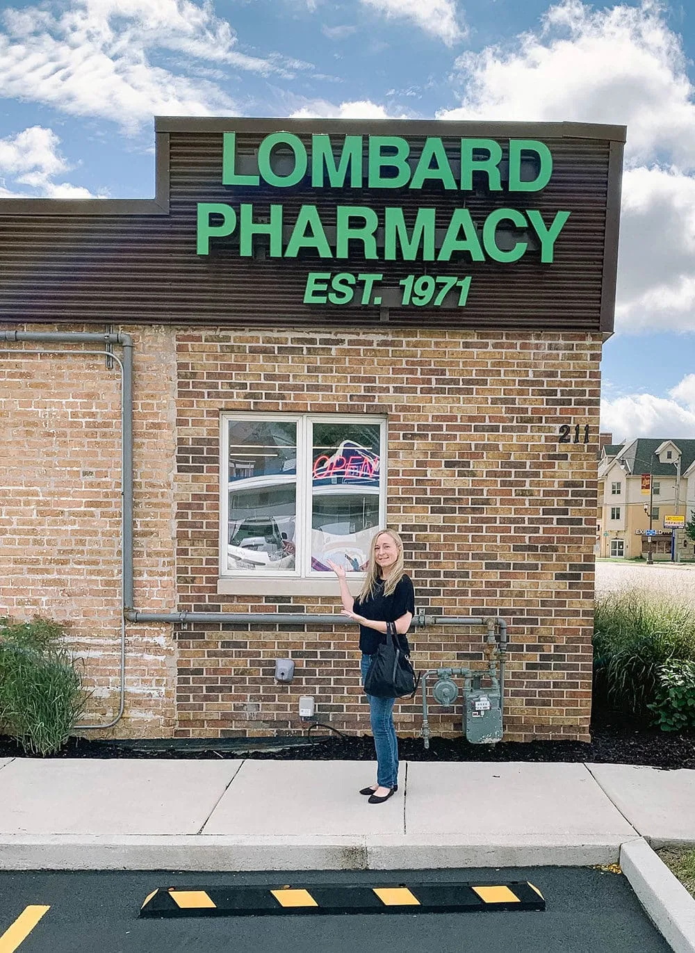 Standing in front of the Lombard Pharmacy. 