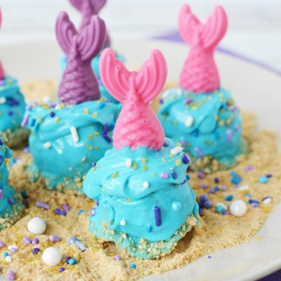 Donuts decorated for an under the sea party with mermaid fins.