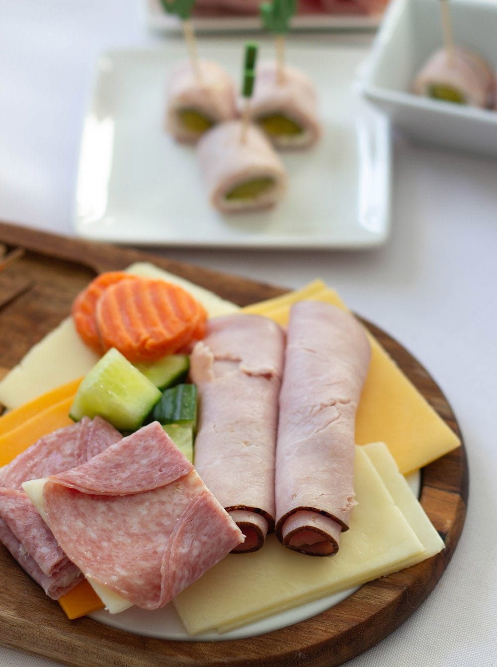 Small charcuterie board with deli meat and veggies. 