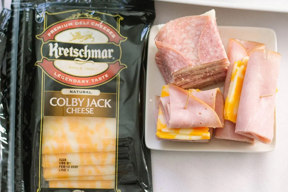 Colby jack and meat on a plate.