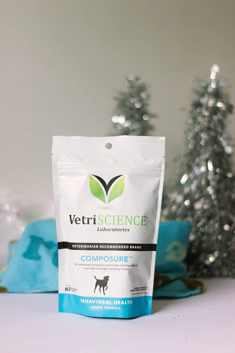 Bag of VetriScience Composure In front of holiday trees and a dog blanket. 